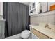 Bathroom with shower/tub combo, vanity sink, and tiled walls at 4152 55 N Way # 1030, Kenneth City, FL 33709