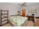 Bedroom featuring a bed with tropical themed comforter, ceiling fan and a wood door to outside at 4152 55 N Way # 1030, Kenneth City, FL 33709