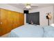 Cozy bedroom with carpeted floors, closet, ceiling fan and a mounted TV at 4152 55 N Way # 1030, Kenneth City, FL 33709