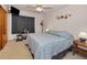 Comfortable bedroom featuring neutral carpet, ceiling fan and mounted TV at 4152 55 N Way # 1030, Kenneth City, FL 33709