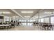 Large community room with tables and chairs, perfect for social events and activities at 4152 55 N Way # 1030, Kenneth City, FL 33709