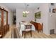 Traditional dining room featuring vintage hutch, laminate floors, and seating for four at 4152 55 N Way # 1030, Kenneth City, FL 33709