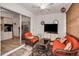 Florida room with wicker furniture, a ceiling fan, TV, and view into the kitchen at 4152 55 N Way # 1030, Kenneth City, FL 33709