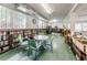 Bright library room with a wall of bookshelves, round table, and four chairs at 4152 55 N Way # 1030, Kenneth City, FL 33709