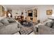 Open-concept living space features comfortable seating, stylish rug, and bright natural light at 4152 55 N Way # 1030, Kenneth City, FL 33709
