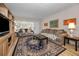 Comfortable living room features neutral tones, laminate floors, and lots of natural light at 4152 55 N Way # 1030, Kenneth City, FL 33709
