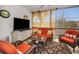 Relaxing sunroom featuring comfortable seating, a TV, and privacy shades at 4152 55 N Way # 1030, Kenneth City, FL 33709
