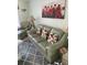 Living room with green leather sofa and glass coffee table at 4199 38Th S Ave # I, St Petersburg, FL 33711