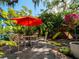 Relaxing backyard patio with seating, umbrella and playset at 509 N Glenwood Ave, Clearwater, FL 33755