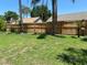 Spacious backyard with a wooden fence and palm trees offering a tranquil outdoor space at 5105 Garden Vale Ave, Tampa, FL 33624