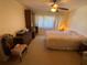 Bedroom with a comfortable bed, dresser, chair and window offers a relaxing retreat at 5105 Garden Vale Ave, Tampa, FL 33624