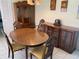 Dining room with wood table, chairs, and a decorative hutch adds elegance to the space at 5105 Garden Vale Ave, Tampa, FL 33624
