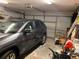 Attached garage with car, storage items, and an automatic garage door at 5105 Garden Vale Ave, Tampa, FL 33624