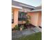 Side of house showing peach-colored walls, landscaping, and walkway at 5105 Garden Vale Ave, Tampa, FL 33624