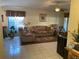 Bright and airy living room with tile floors and ample seating at 5105 Garden Vale Ave, Tampa, FL 33624