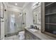 Modern bathroom with glass shower and grey tile at 5120 W Longfellow Ave, Tampa, FL 33629