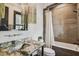 Clean bathroom with a shower/tub combo and granite vanity at 5120 W Longfellow Ave, Tampa, FL 33629