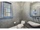 Powder room with vessel sink and dark wallpaper at 5120 W Longfellow Ave, Tampa, FL 33629