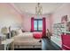 Bright bedroom with a comfortable bed and pink accents at 5120 W Longfellow Ave, Tampa, FL 33629