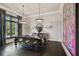 Elegant dining room featuring a large table, chandelier, and stunning artwork at 5120 W Longfellow Ave, Tampa, FL 33629