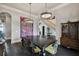 Open dining room with a large table, statement art, and view to staircase at 5120 W Longfellow Ave, Tampa, FL 33629
