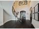 Grand entry with curved staircase and dark hardwood floors at 5120 W Longfellow Ave, Tampa, FL 33629