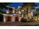 Elegant waterfront home with beautifully landscaped grounds at night at 5120 W Longfellow Ave, Tampa, FL 33629