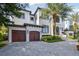 Luxury home with two-car garage and manicured landscaping at 5120 W Longfellow Ave, Tampa, FL 33629