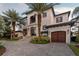 Stunning waterfront home with a two-car garage and lush landscaping at 5120 W Longfellow Ave, Tampa, FL 33629