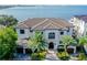Stunning waterfront home with tile roof and palm trees at 5120 W Longfellow Ave, Tampa, FL 33629