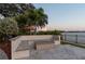 Outdoor fire pit with built-in seating and waterfront views at 5120 W Longfellow Ave, Tampa, FL 33629