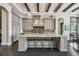 Gourmet kitchen with an island, stainless steel appliances, and dark wood cabinets at 5120 W Longfellow Ave, Tampa, FL 33629