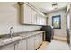 Bright laundry room with granite countertops and modern appliances at 5120 W Longfellow Ave, Tampa, FL 33629