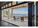 Open patio with folding glass doors revealing panoramic water views at 5120 W Longfellow Ave, Tampa, FL 33629