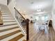 Modern staircase with dark wood accents leading to an open living space at 6009 Palm Key Ave, Oldsmar, FL 34677