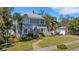 Two-story house with gray siding, palm trees, and a manicured lawn at 602 33Rd Street W Ct, Bradenton, FL 34205