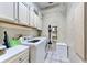 Laundry room with washer, dryer, cabinets, and built-in shelving at 706 Eagle Ln, Apollo Beach, FL 33572