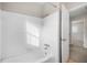 Simple bathroom with white tile and a bathtub at 921 Orangeview Dr, Largo, FL 33778