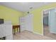 Bedroom with wood floors, closet, shelving, and bright-yellow painted walls at 9626 Channing Hill Dr, Ruskin, FL 33573