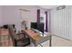 Bedroom with wood floors, a desk with monitors, and light purple painted walls at 9626 Channing Hill Dr, Ruskin, FL 33573