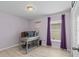 Bright bedroom featuring wood floors, a desk with computer and lilac painted walls at 9626 Channing Hill Dr, Ruskin, FL 33573