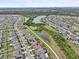 Aerial view of a house in a residential neighborhood near a lake at 9626 Channing Hill Dr, Ruskin, FL 33573