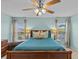 Light teal bedroom with wooden sleigh bed and ceiling fan at 9626 Channing Hill Dr, Ruskin, FL 33573