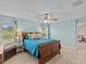 Bedroom with a wooden bed, light blue walls, and ceiling fan at 9626 Channing Hill Dr, Ruskin, FL 33573