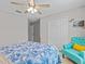 Bedroom with a bed, teal chair, and double doors to closet at 9626 Channing Hill Dr, Ruskin, FL 33573