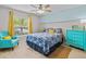 Bright bedroom with a comfy bed, teal accent chair, and dresser at 9626 Channing Hill Dr, Ruskin, FL 33573