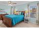Spacious bedroom with wood sleigh bed and light blue walls at 9626 Channing Hill Dr, Ruskin, FL 33573