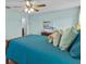 Primary bedroom with teal bedding and ensuite bathroom access at 9626 Channing Hill Dr, Ruskin, FL 33573