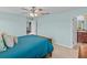 Guest bedroom with teal bedding and access to bathroom at 9626 Channing Hill Dr, Ruskin, FL 33573