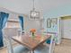 Bright dining room features a wood table and light blue walls at 9626 Channing Hill Dr, Ruskin, FL 33573